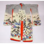 A GOOD JAPANESE 19TH CENTURY EMBROIDERED TEXTILE KIMONO / ROBE, embroidered to depict scenes of