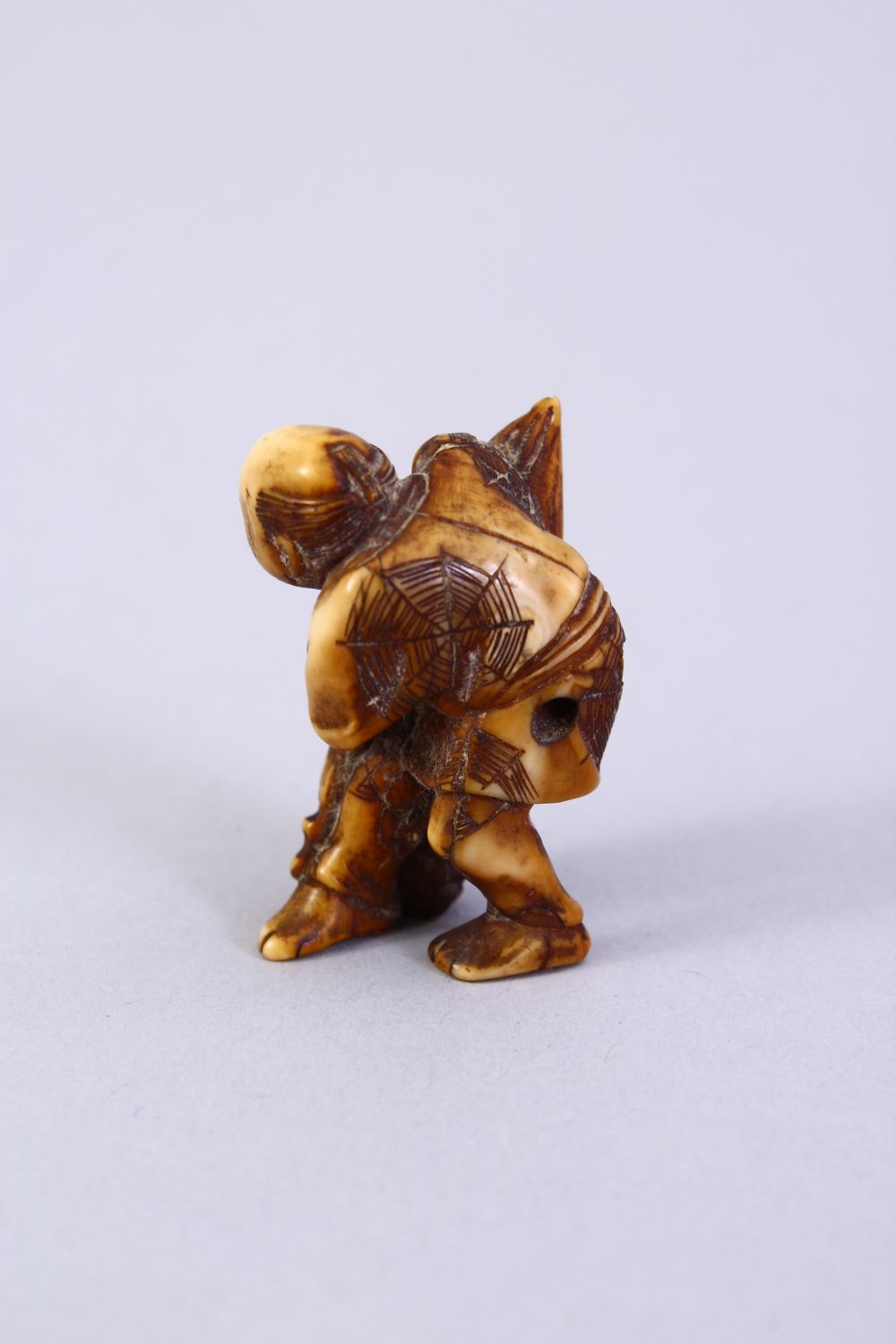 A JAPANESE MEIJI PERIOD CARVED IVORY NETSUKE, the figure holding a tied parcel, signed to side, 3. - Image 4 of 6