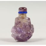 A GOOD CHINESE AMETHEYST COLOURED STONE / CRYSTAL SCENT BOTTLE, carved with lion dogs and foliage,