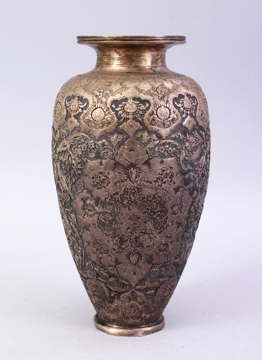 A 18TH / 19TH CENTURY IRANIAN CARVED SILVER VASE, with a multitude of decoration depicting flora and