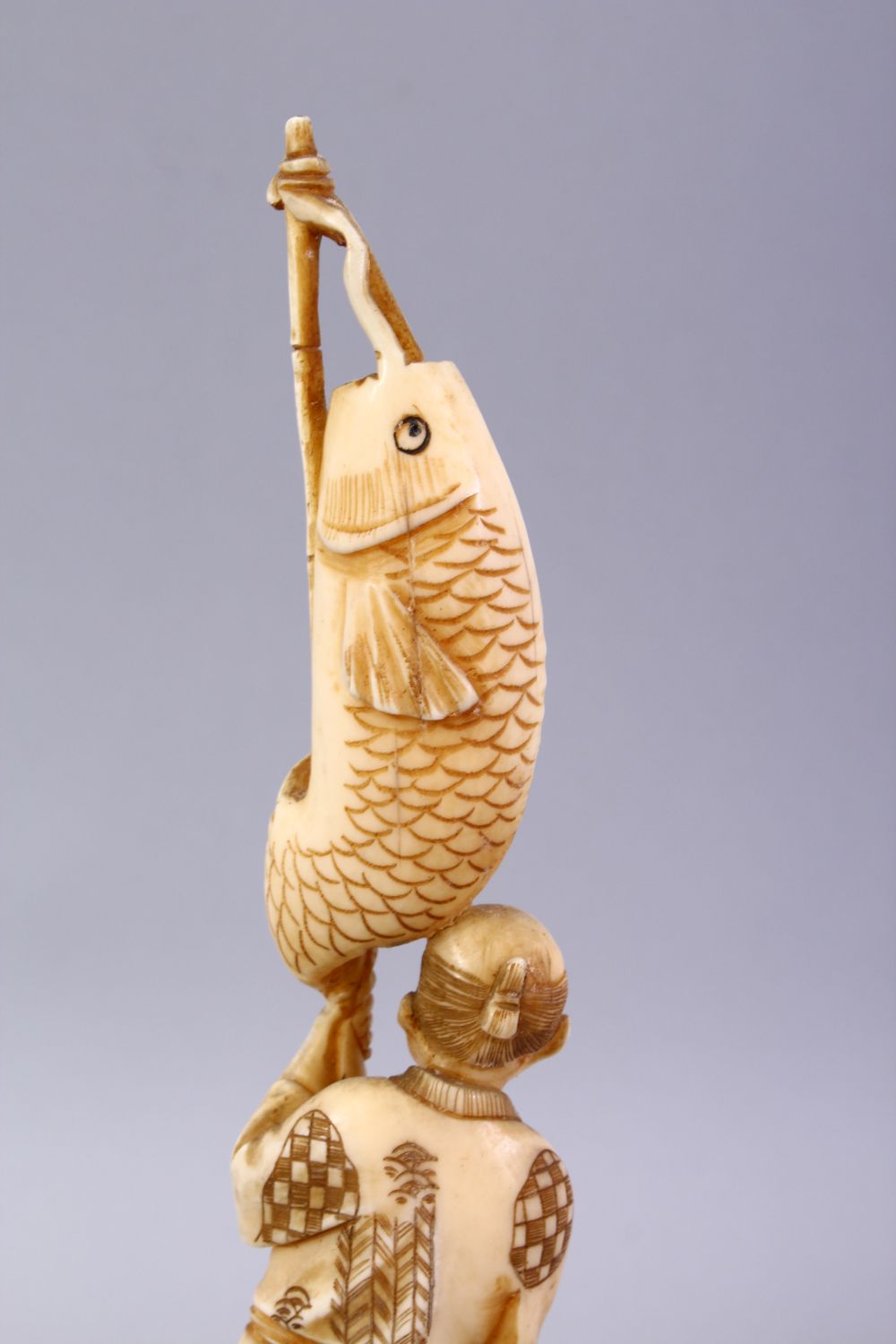 A JAPANESE MEIJI PERIOD CARVED IVORY OKIMONO - FISHERMAN, The man stood holding his rod and catch, - Image 5 of 9