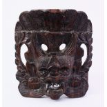 AN ORIENTAL CARVED HARDWOOD MASK, 13CM