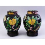 A GOOD PAIR OF 19TH / 20TH CENTURY CHINESE CLOISONNE JARS, COVERS & STANDS, the jard with a black