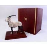 A RARE WHITE METAL QATARI FIGURE OF AN IBEX, standing on a plinth, complete with original box,