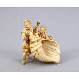 A JAPANESE MEIJI PERIOD CARVED IVORY OKIMONO - MAN & SHELL, three men stood holding a conch shell,
