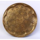 A GOOD LARGE PERSIAN QAJAR BRASS CIRCULAR TRAY, engraved with numerous panels of seated figures