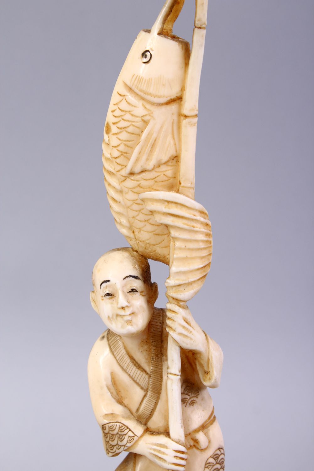 A JAPANESE MEIJI PERIOD CARVED IVORY OKIMONO - FISHERMAN, The man stood holding his rod and catch, - Image 2 of 9