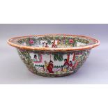 A GOOD LARGE CHINESE CANTON FAMILLE ROSE PORCELAIN BASIN, decorated with panels of figures in