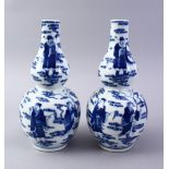 A GOOD PAIR OF CHINESE BLUE & WHITE PORCELAIN DOUBLE GOURD VASES, decorated with scenes of