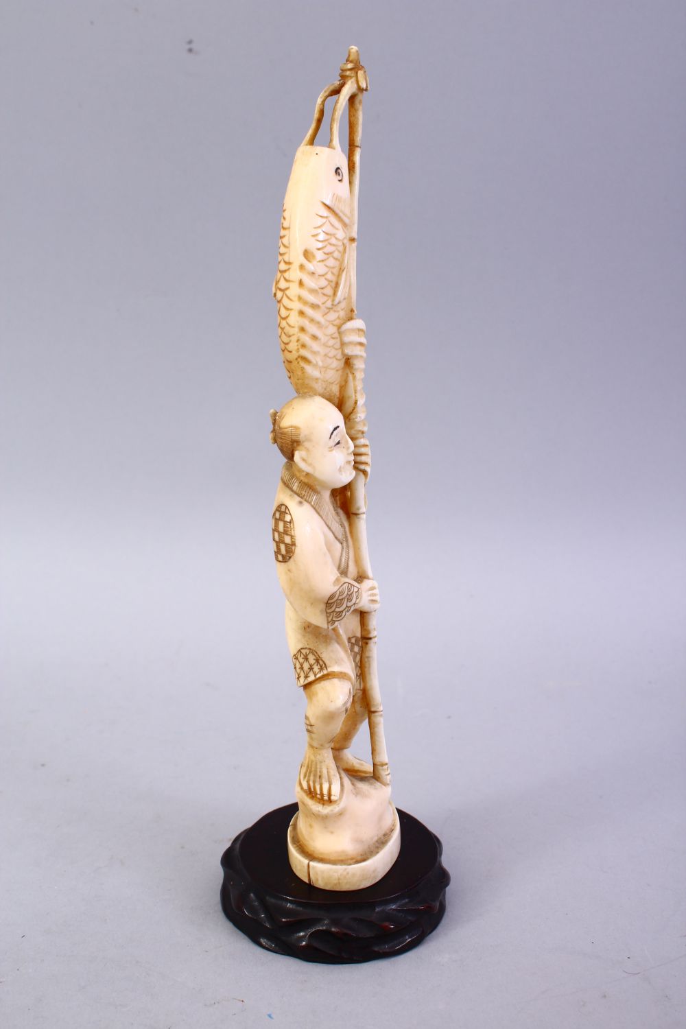 A JAPANESE MEIJI PERIOD CARVED IVORY OKIMONO - FISHERMAN, The man stood holding his rod and catch, - Image 3 of 9