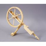 A FINE 19TH CENTURY ANGLO INDIAN CARVED IVORY SEWING IMPLEMENT, comprising of a large wheel, small