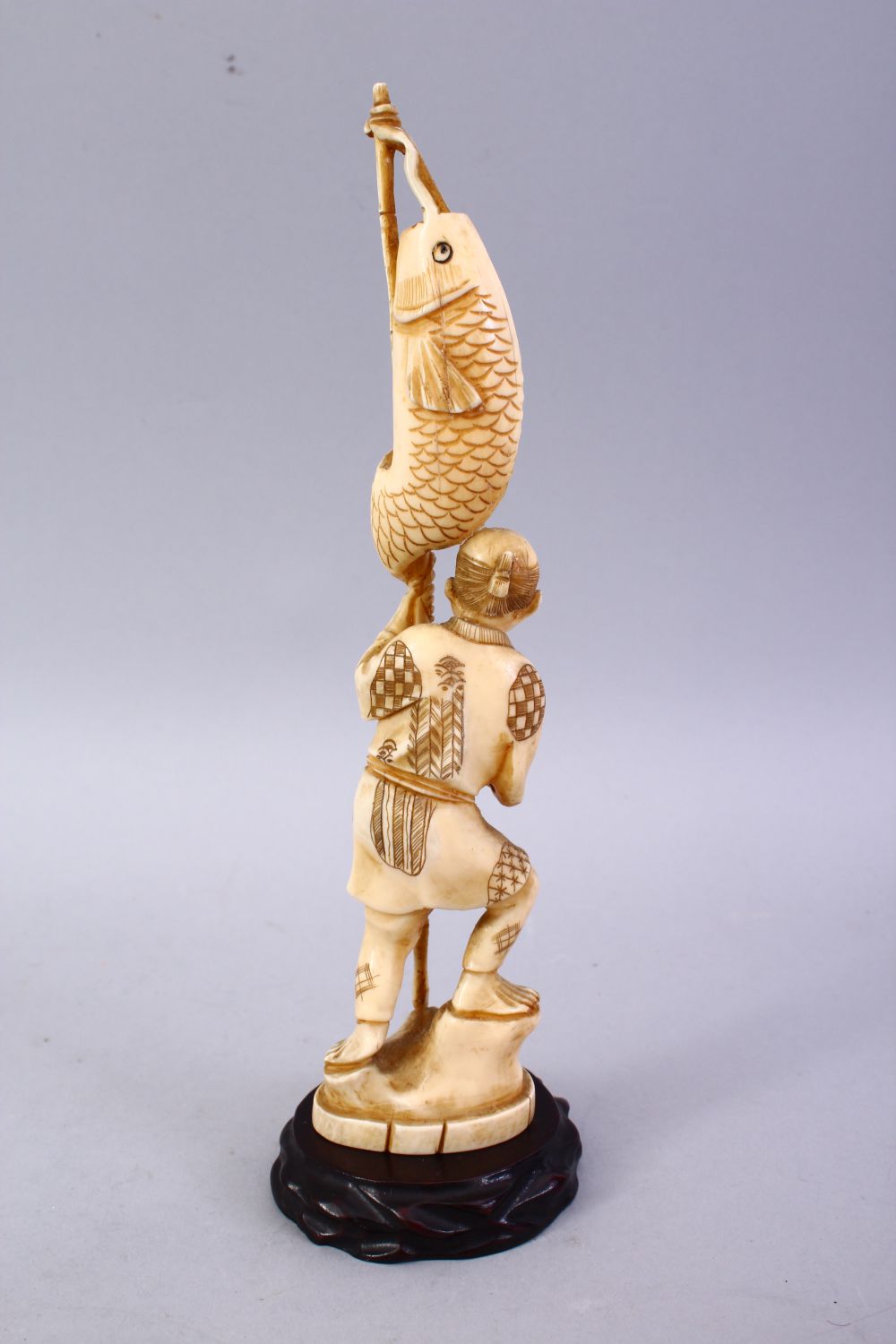 A JAPANESE MEIJI PERIOD CARVED IVORY OKIMONO - FISHERMAN, The man stood holding his rod and catch, - Image 4 of 9