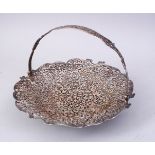 A FINE INDIAN SILVER OPENWORK SWING HANDLED BASKET, of engraved leaf and flower head design, 23cm