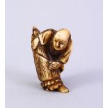 A JAPANESE MEIJI PERIOD CARVED IVORY NETSUKE, the figure holding a tied parcel, signed to side, 3.