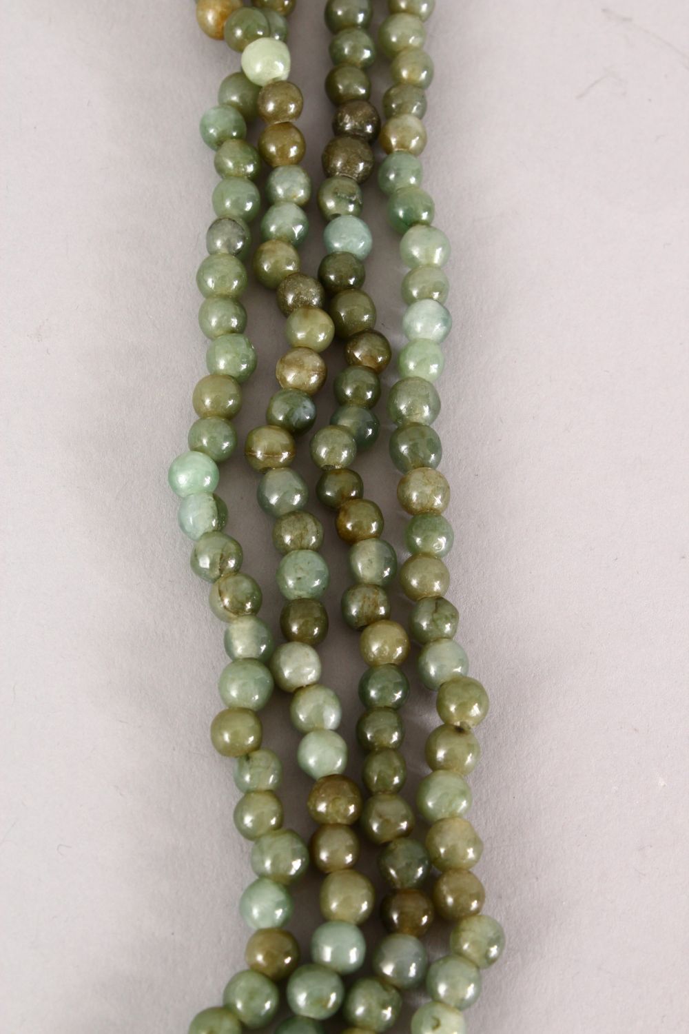 A GOOD CHINESE CARVED JADE / HARD STONE BEAD NECKLACE, with seven runs of beads, Approx 55cm. - Image 2 of 4