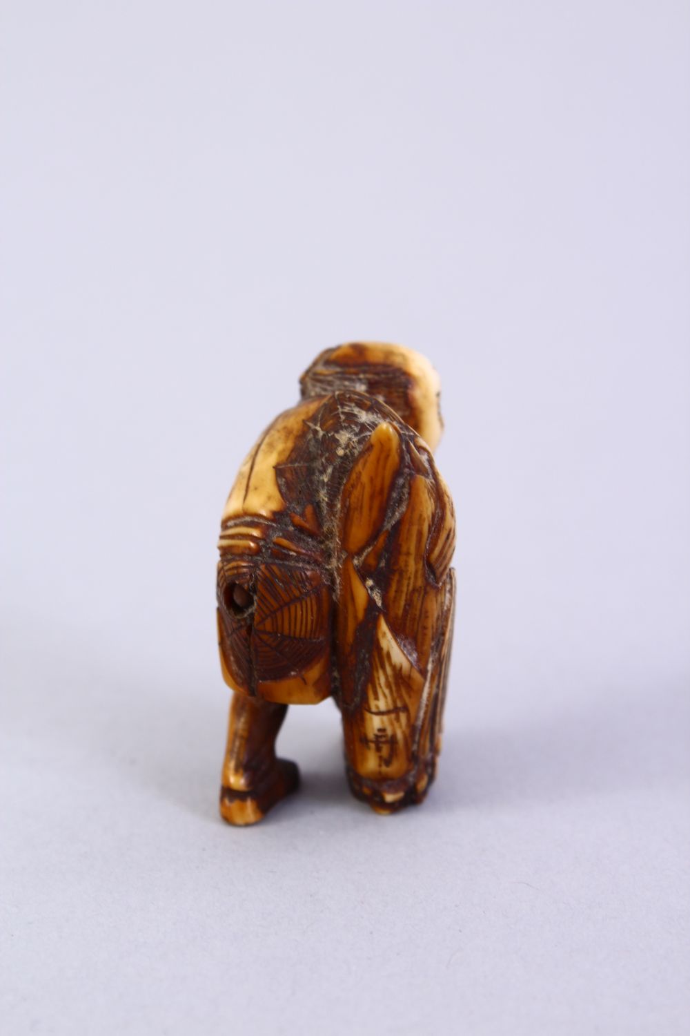 A JAPANESE MEIJI PERIOD CARVED IVORY NETSUKE, the figure holding a tied parcel, signed to side, 3. - Image 3 of 6