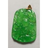 A CHINESE CARVED APPLE GREEN JADE PENDANT. 2ins high.