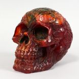 A RESIN MODEL OF A HUMAN SKULL. 6.5ins long.