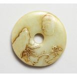 A SMALL CHINESE CARVED JADE BI DISC. 2.5ins diameter.