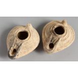 TWO SMALL TERRACOTTA OIL LAMPS.