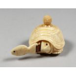 A CARVED BONE TORTOISE TAPE MEASURE.