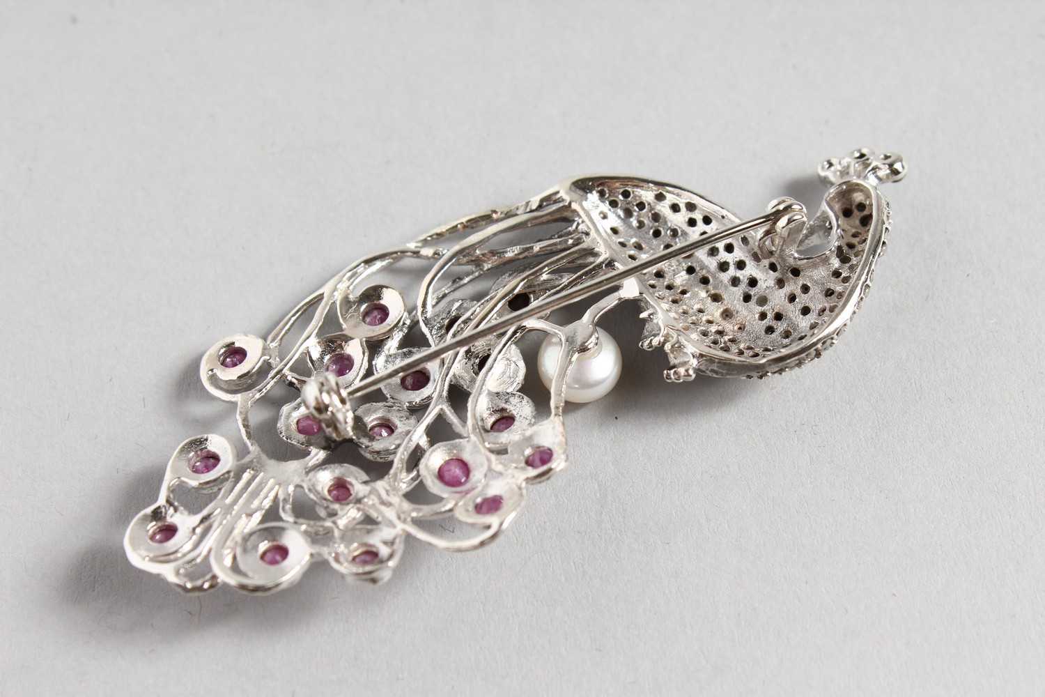 A SILVER, RUBY, PEARL AND MARCASITE PEACOCK BROOCH. - Image 2 of 2