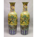 A LARGE PAIR OF CHINESE FAMILLE JAUNE FLOOR STANDING VASES. 56ins high.