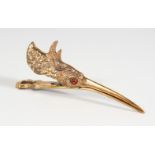 A NOVELTY BRASS "SNIPE" HEAD LETTER CLIP with glass eyes. 5ins long.