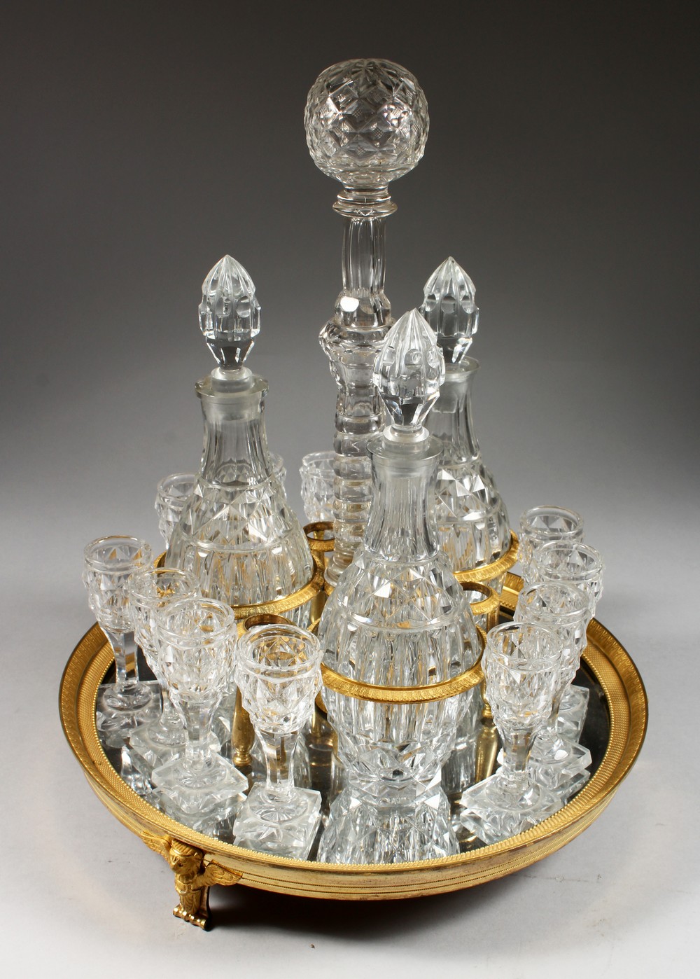A SUPERB PIERRE-PHILIPPE THOMIRE MERCURY GILDED CIRCULAR DRINKS SET, complete with three decanters