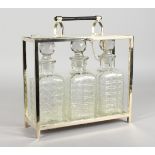 A GOOD CHRISTOPHER DRESSER DESIGN THREE BOTTLE TANTALUS.