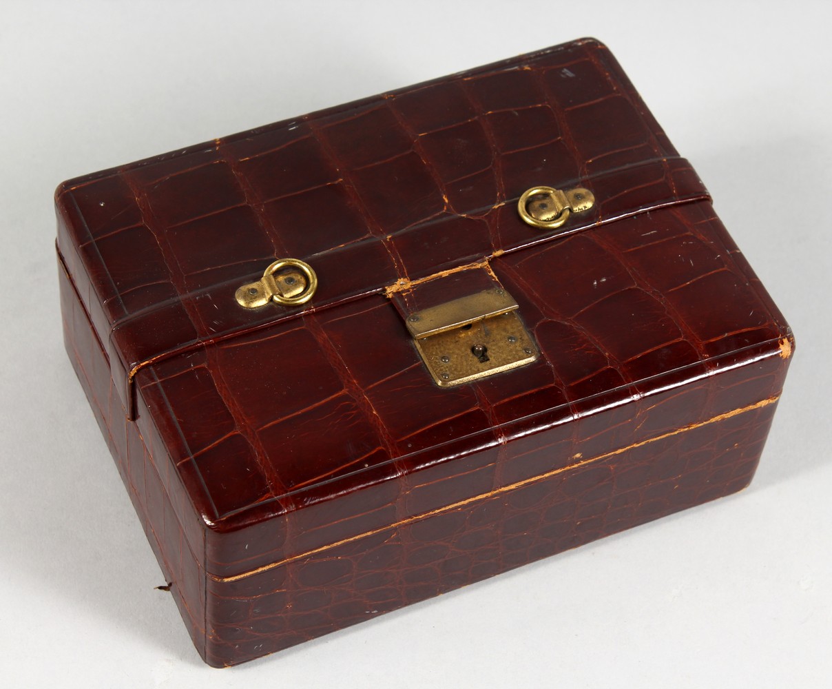 A SMALL LEATHER JEWELLERY BOX (AF). 7ins wide.