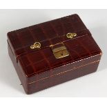 A SMALL LEATHER JEWELLERY BOX (AF). 7ins wide.