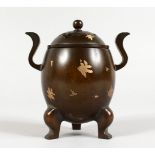 A SMALL CHINESE GOLD SPLASH TWIN-HANDLED BRONZE CENSER ON THREE FEET. 4.75ins high.