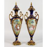A SUPERB PAIR OF DARK BLUE GROUND SEVRES TWO-HANDLED URNS AND COVERS, with gilt decoration and