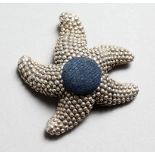 A SMALL NOVELTY SILVER STARFISH PIN CUSHION. 1.5ins.