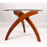 TABLEMAKERS of WIMBLEDON, LONDON, A BALLERINA TABLE, with three curving cherry wood legs, united
