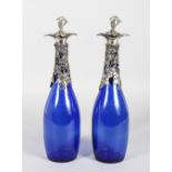 A GOOD PAIR OF BRISTOL BLUE GLASS DECANTERS, with fruiting vine mounts. 12ins high.