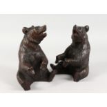 A GOOD PAIR OF BLACK FOREST CARVED WOOD SEATED BEAR TOBACCO JARS AND COVERS. 8ins high