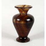A STONE BALUSTER-SHAPED VASE. 8ins high.