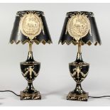 A PAIR OF BLACK TOLEWARE STYLE URN SHAPED LAMPS AND BASES. 22ins high.