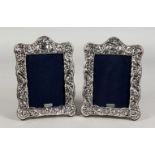 A PAIR OF EMBOSSED SILVER PHOTOGRAPH FRAMES. 7.5ins x 5.75ins.