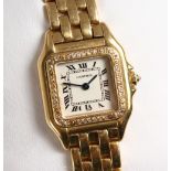 A VERY GOOD 18CT YELLOW GOLD CARTIER WRISTWATCH, the face surrounded by small diamonds, No.