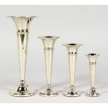 FOUR SMALL TRUMPET VASES.