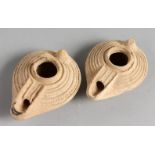 TWO SMALL TERRACOTTA OIL LAMPS.