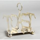 A SMALL SILVER-PLATED TOAST RACK. 4.5ins long.