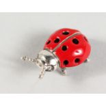 A MINIATURE SILVER AND ENAMEL LADYBIRD. 1ins long.