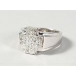 A VERY GOOD 18CT WHITE GOLD CROSS SHAPED DIAMOND RING.