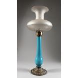 A LATE 19TH CENTURY OPAQUE BLUE GLASS AND BRASS LAMP BASE, with frosted glass shade. 22ins high.