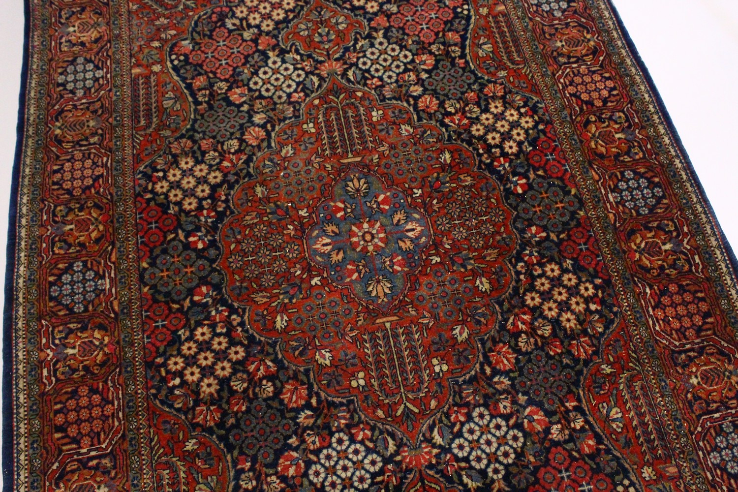 A KASHAN RUG, 20th Century dark blue ground with allover stylized tree and flower decoration. 6ft - Image 2 of 8