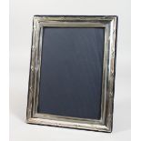 AN UPRIGHT SILVER PHOTOGRAPH FRAME. 10ins x 7.5ins.